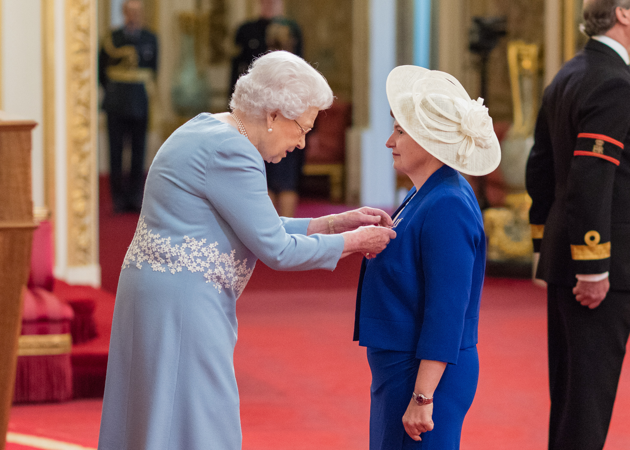 HM The Queen presenting Fiona Raymemt with her OBE .jpg